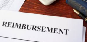 A desk with "Reimbursement" on a paper